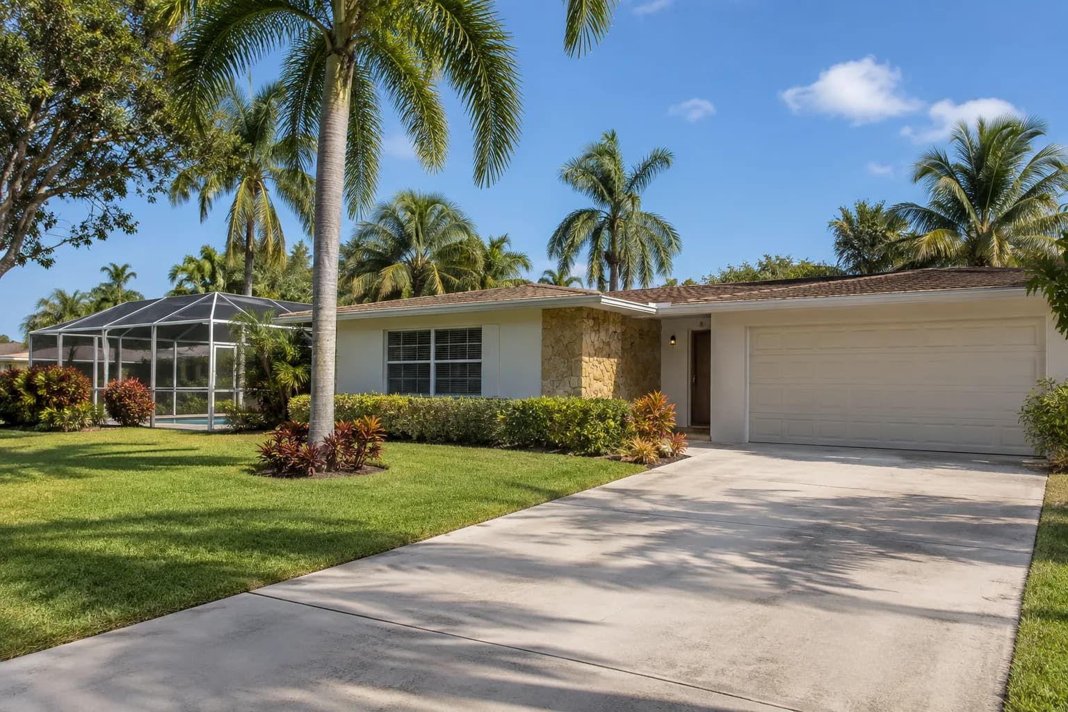 A single-family Tamiami home with a screened pool enclosure