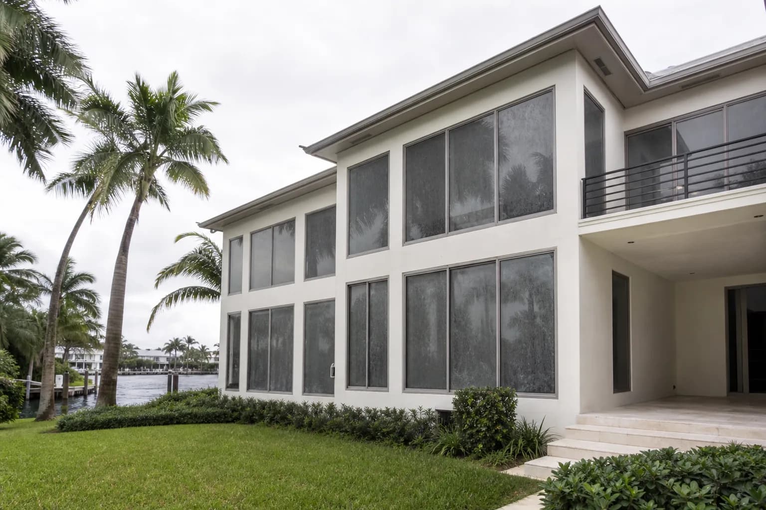 Exterior windows of a waterfront home dulled by salt film