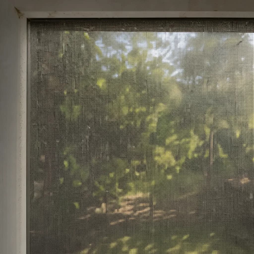 A window screen grey with dust and pollen before washing